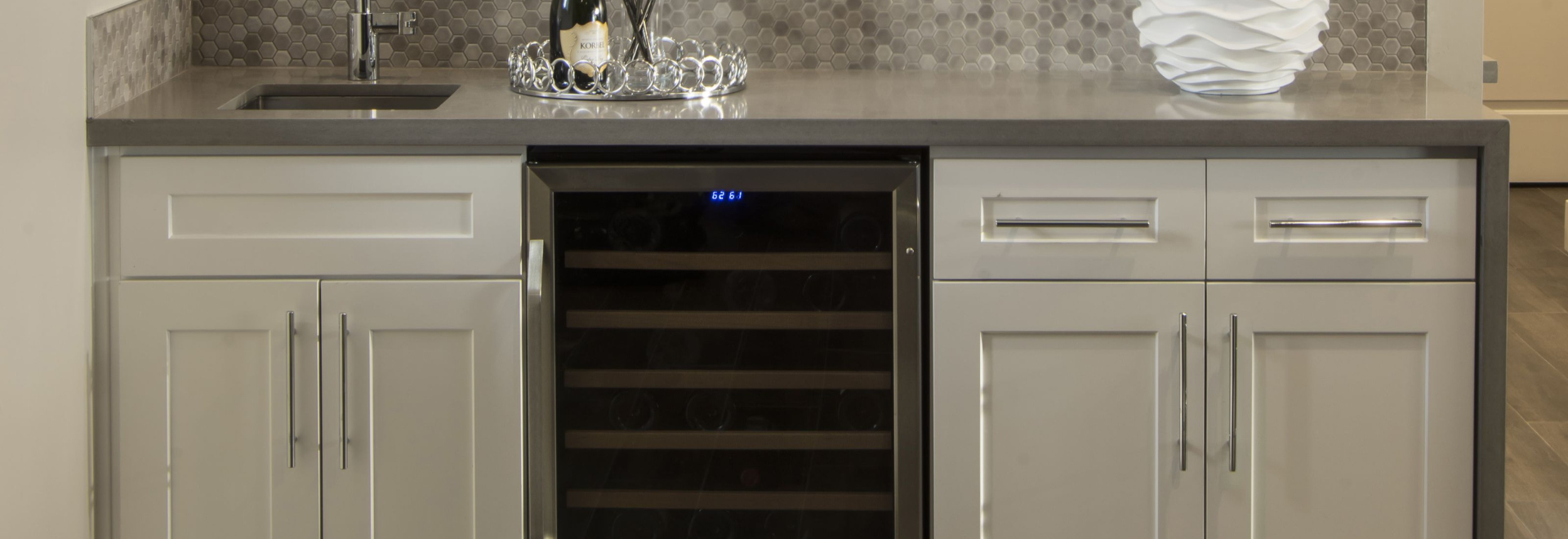 Built-in wine cooler with wooden shelves in a modern kitchen.