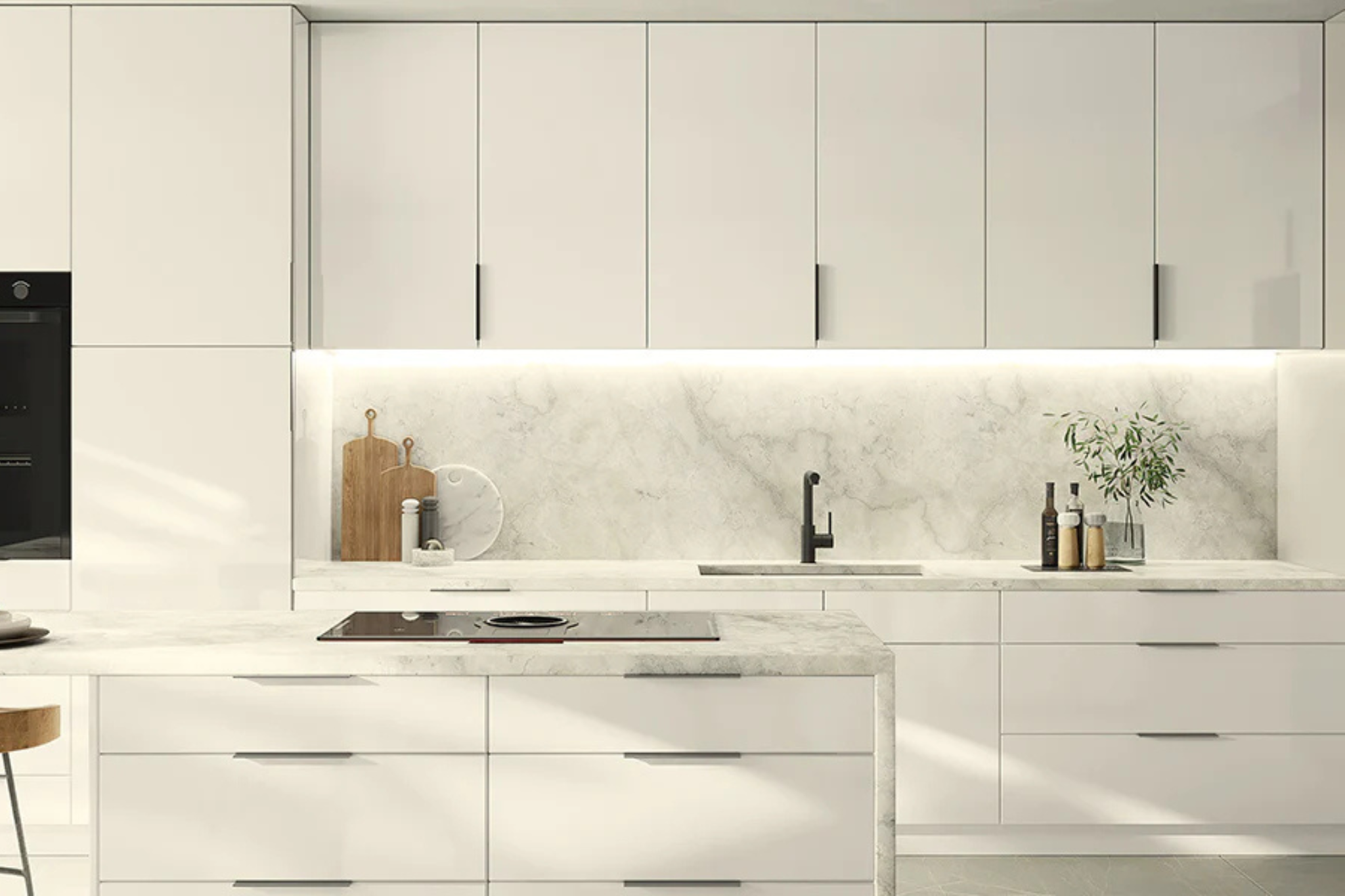 Sleek modern kitchen with white cabinetry and marble backsplash.